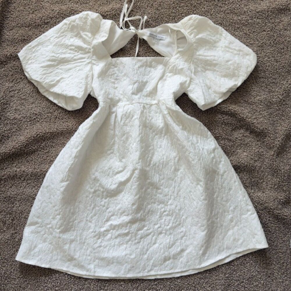 White textured puff sleeve dress with square neckline fitted bodice and tie back
